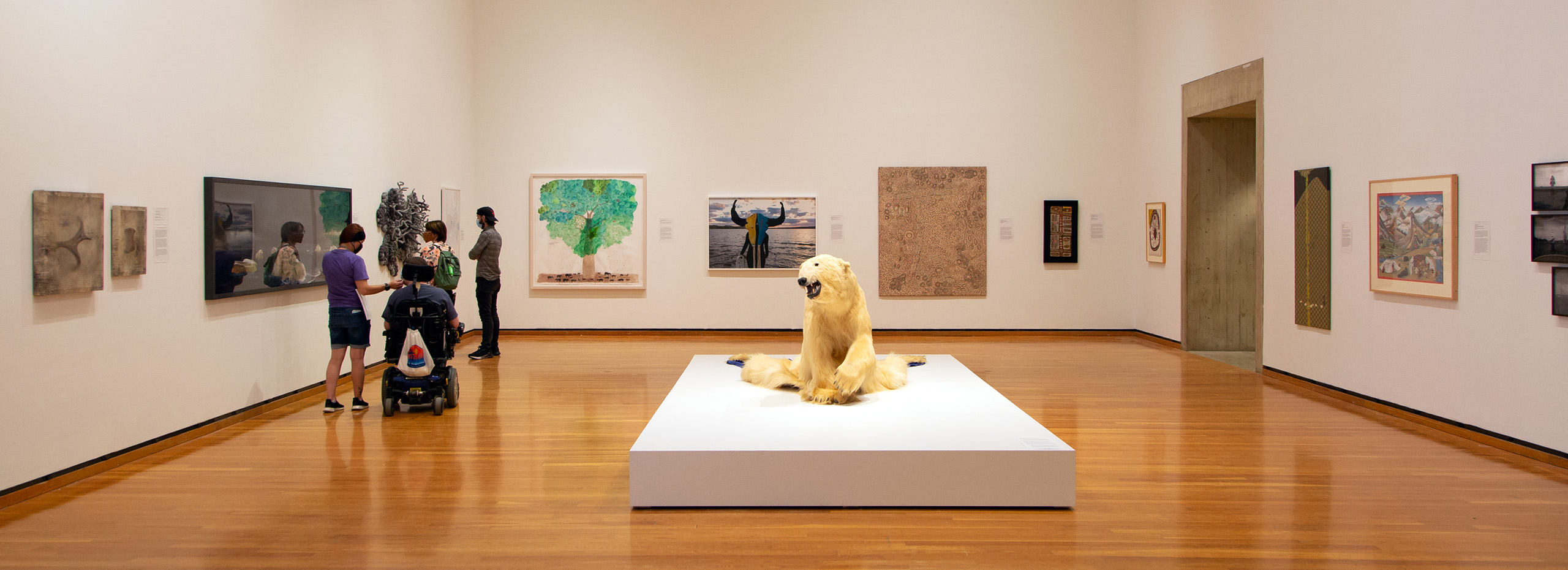 A large gallery of artworks and visitors also contains a taxidermied polar bear installation