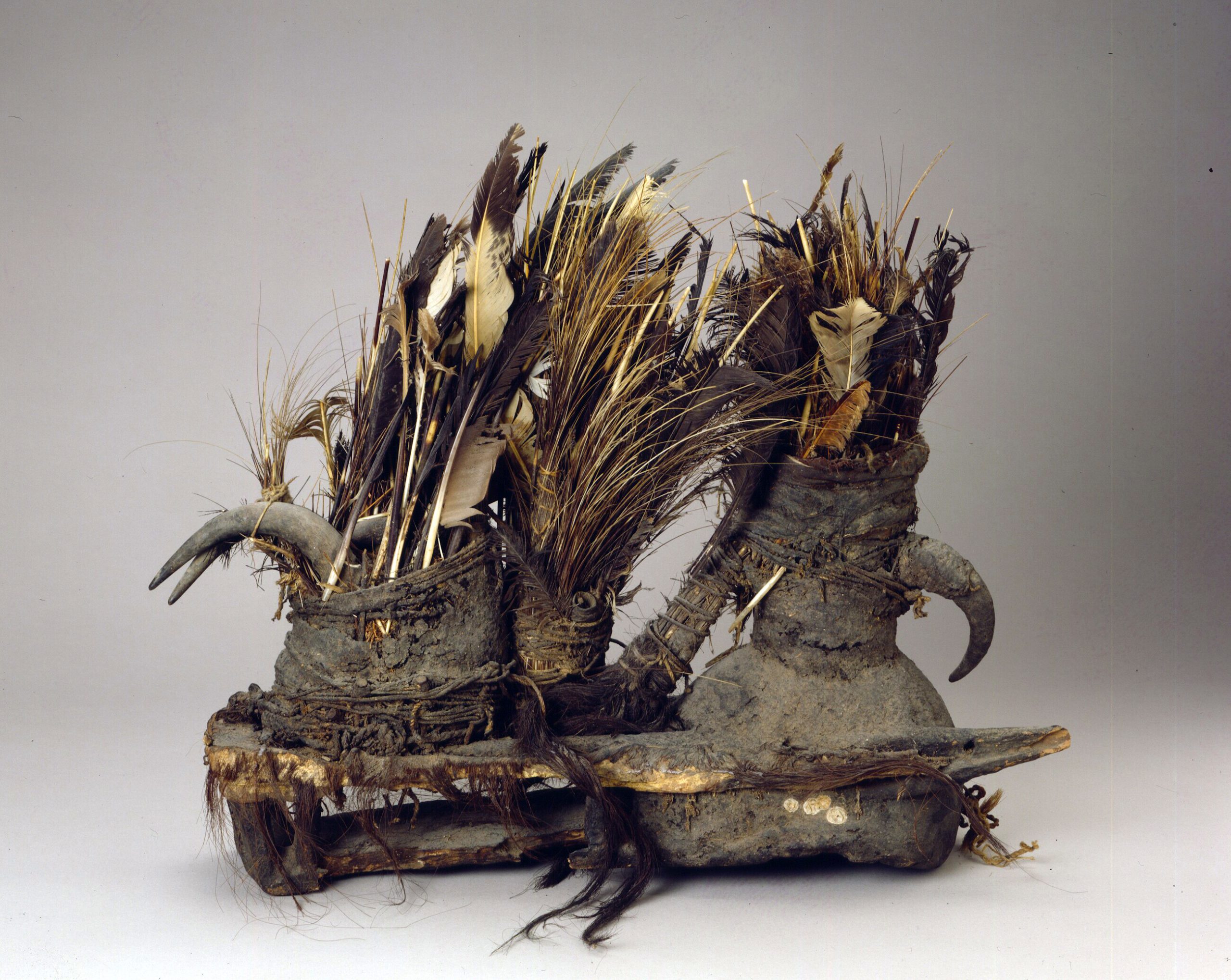 A headdress made of feathers, quills, horns, and other natural materials