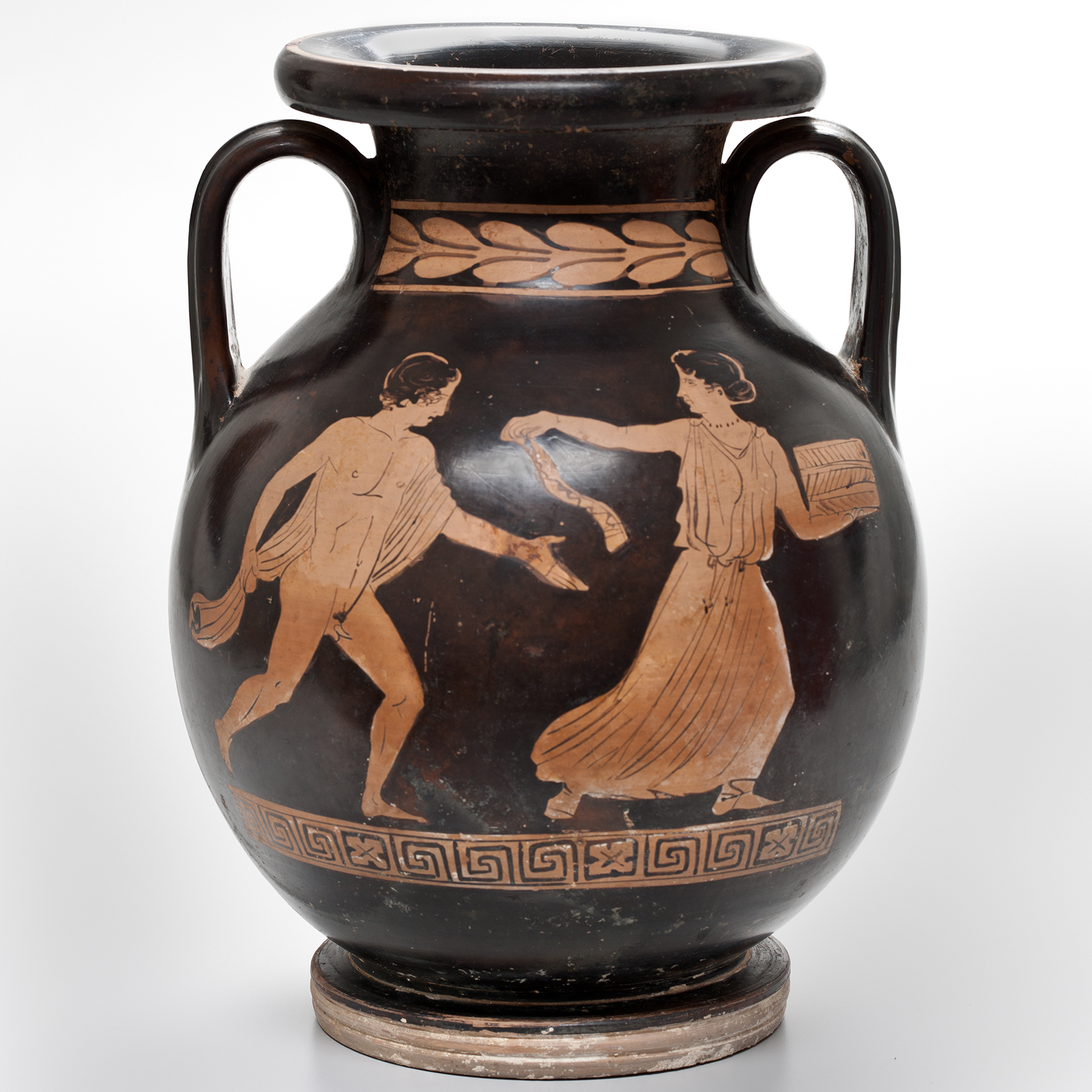 A black jug with two handles and a design of Roman figures and borders