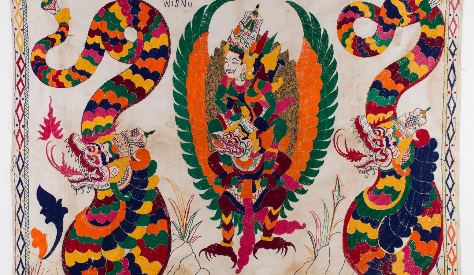 A colorful embroidered tapestry with humans, dragons, and winged creatures