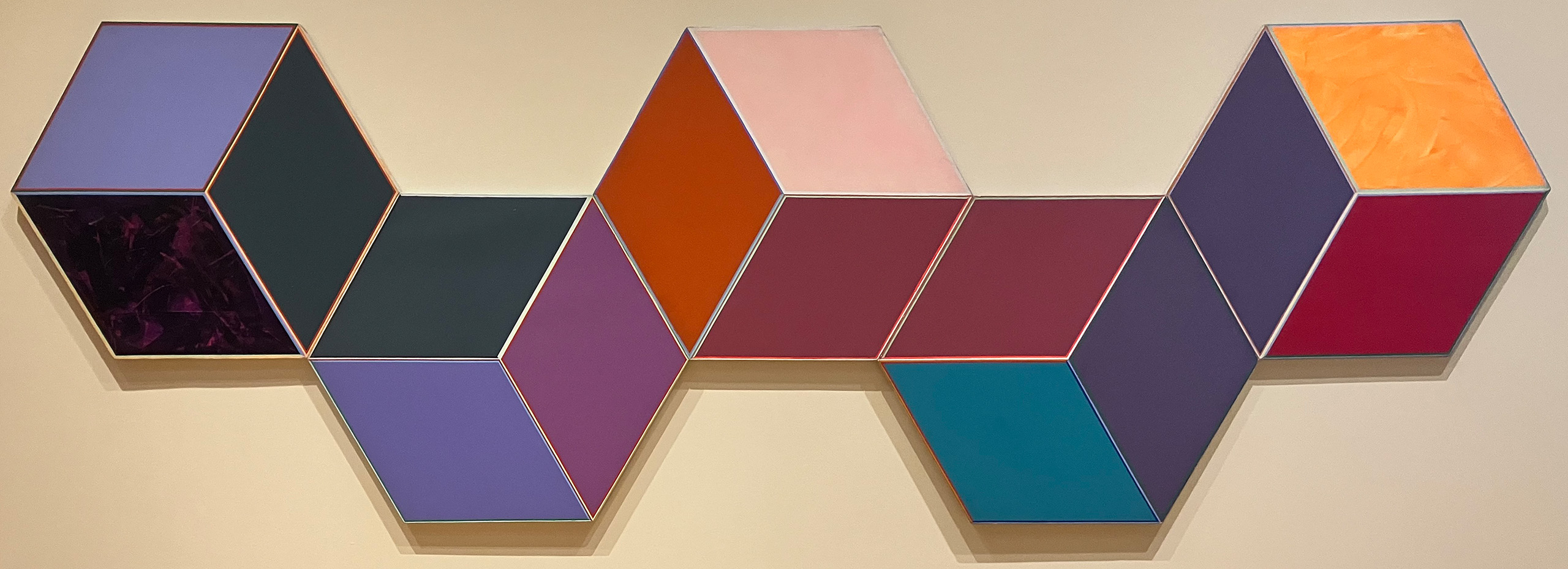 Five adjacent paintings in bright colors shaped like cubes