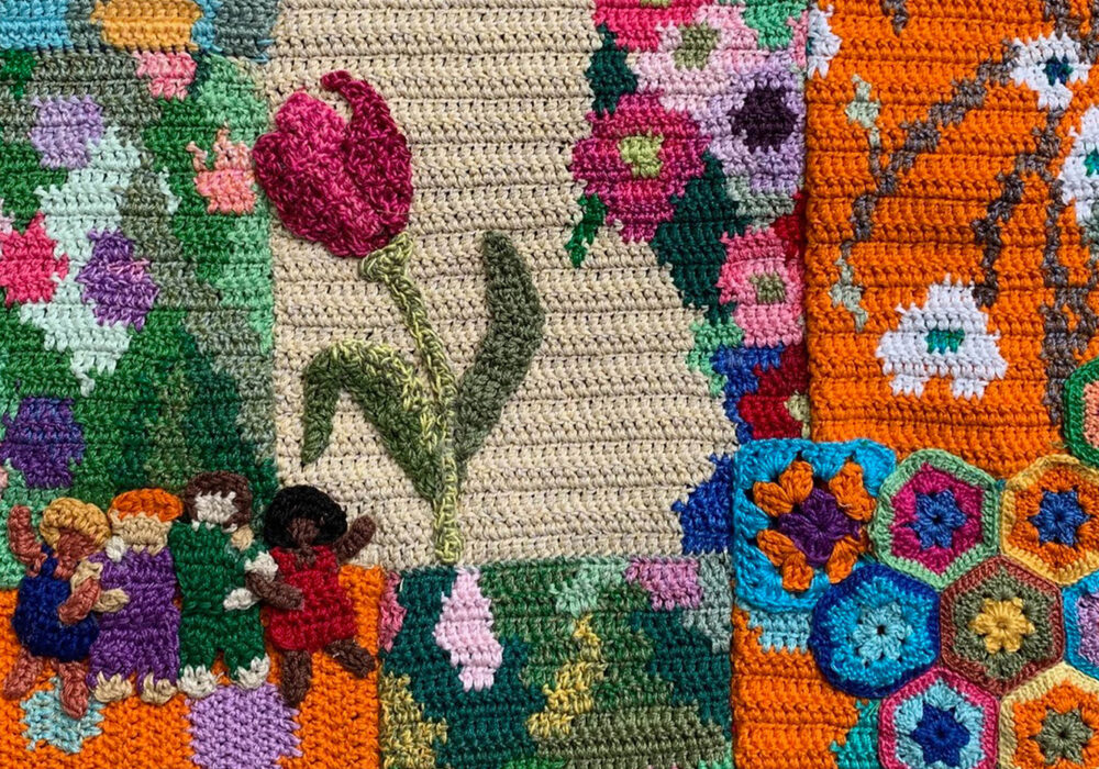 A colorful patchwork of crocheted flowers, people, and patterns
