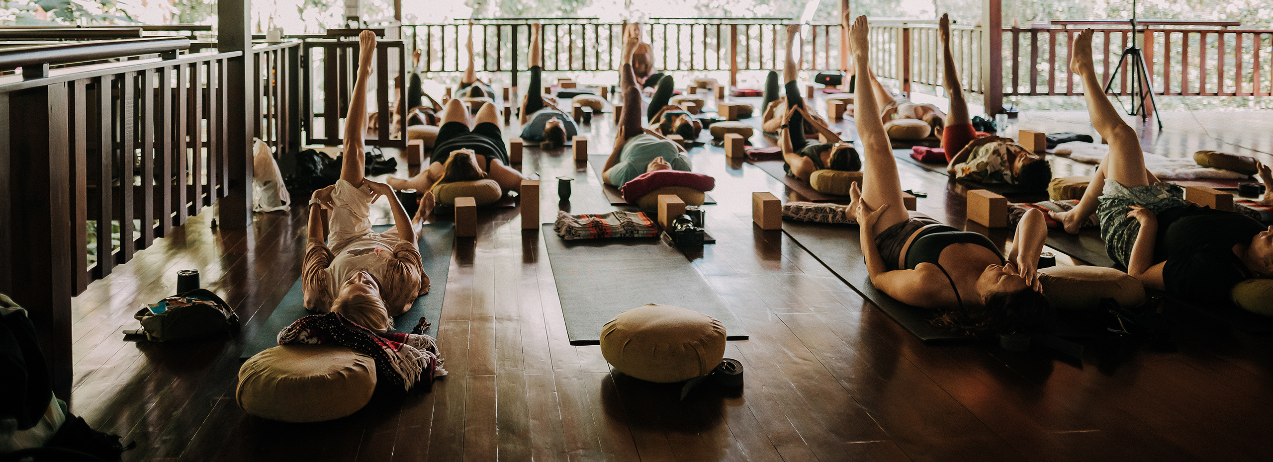 A group of people in a yoga class in an outdoor space