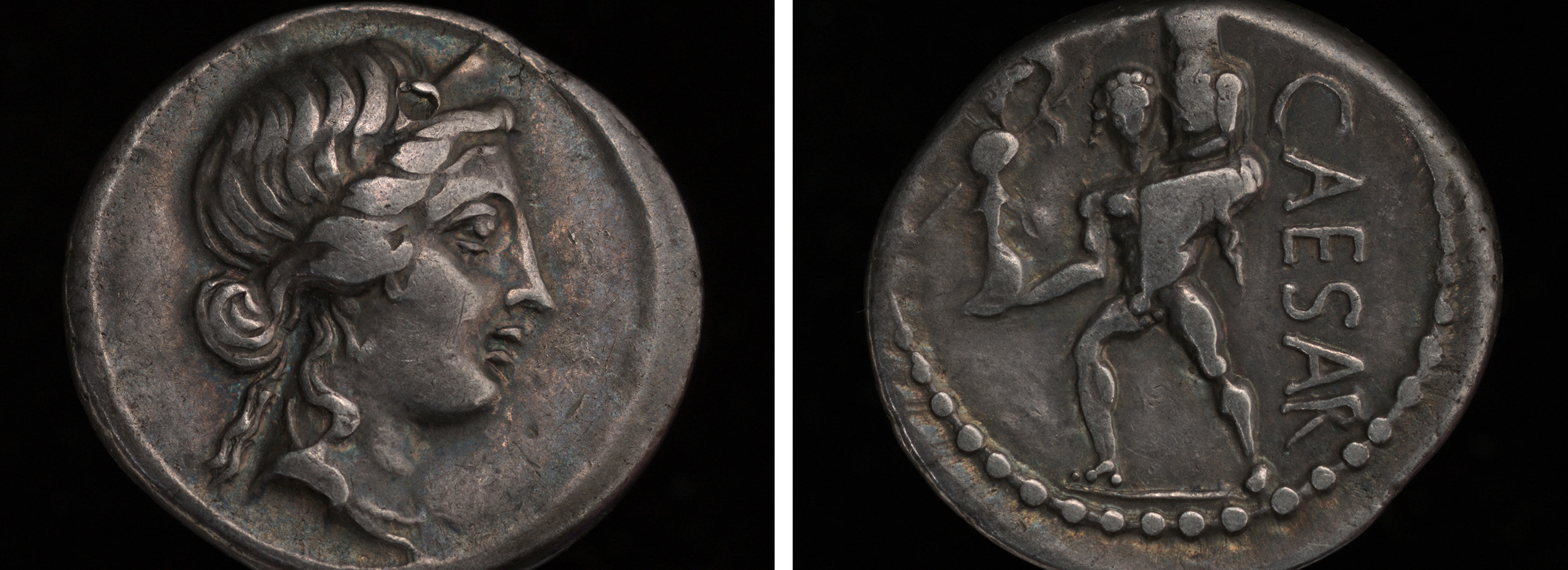 Two sides of a small silver coin show images of Julius Caesar