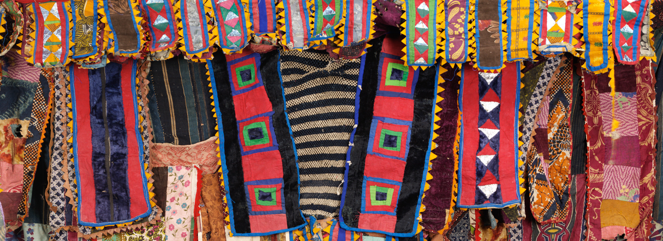 A garment constructed of brightly colored patterned fabrics