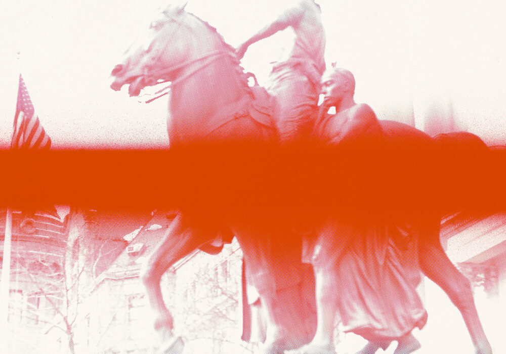 A red duotone photograph of a statue of two figures and a horse with an American flag in the distance