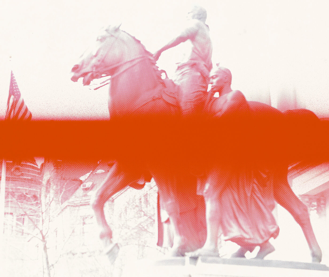 A red duotone photograph of a statue of two figures and a horse with an American flag in the distance