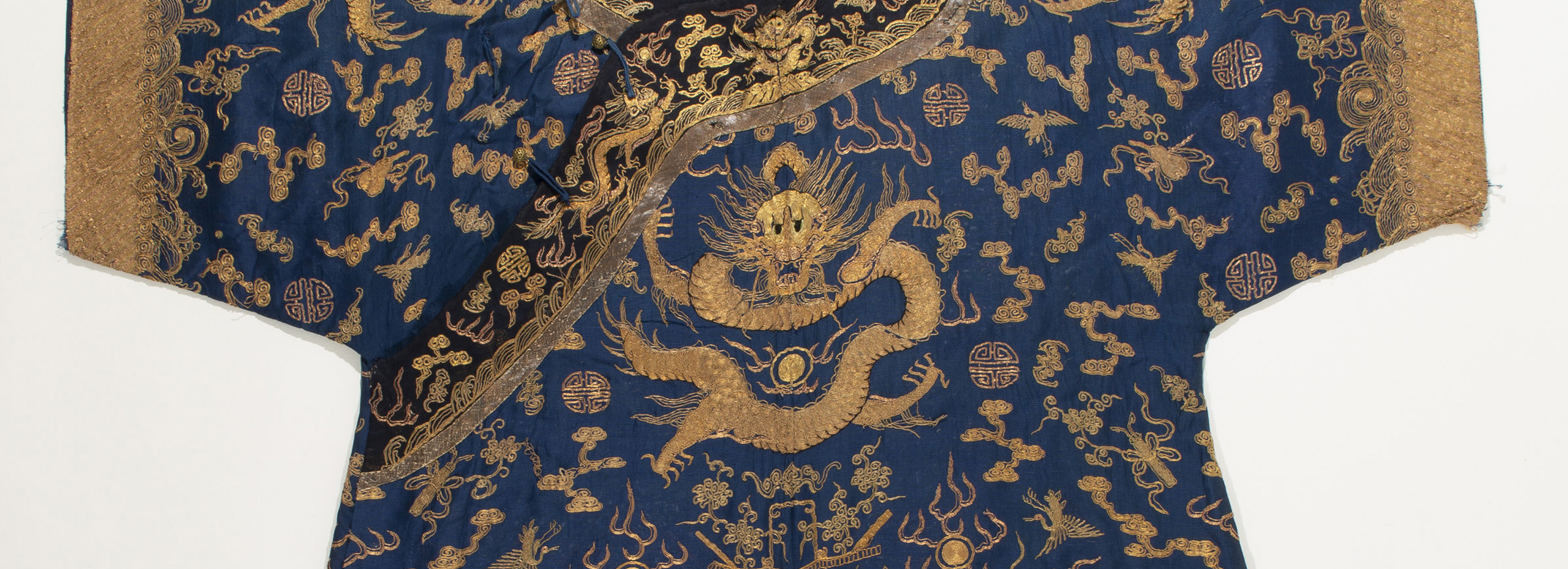 A robe with dark blue and gold designs of dragons