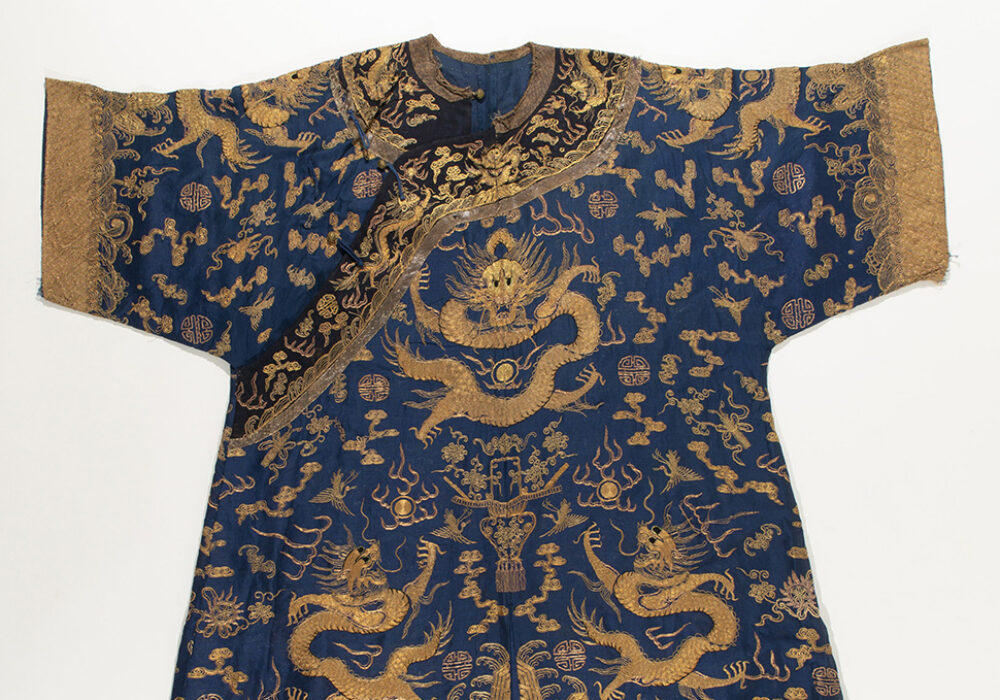 A robe with dark blue and gold designs of dragons