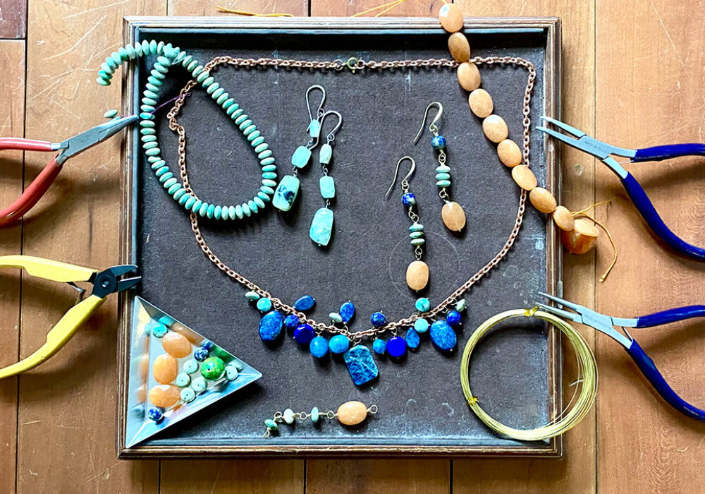 A box of beaded jewelry and wire cutting tools
