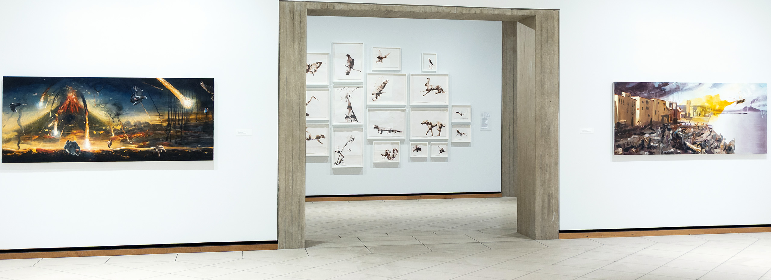 Gallery installation of two large paintings on either side of a doorway leading to a salon wall of drawings