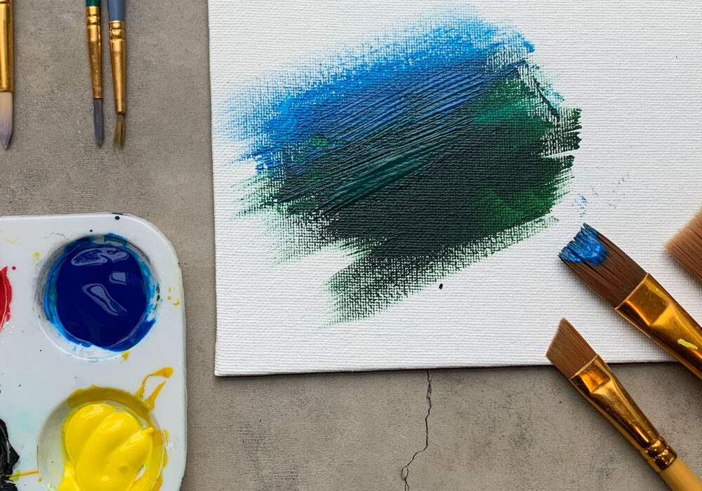 Paints and paintbrushes on a workshop table