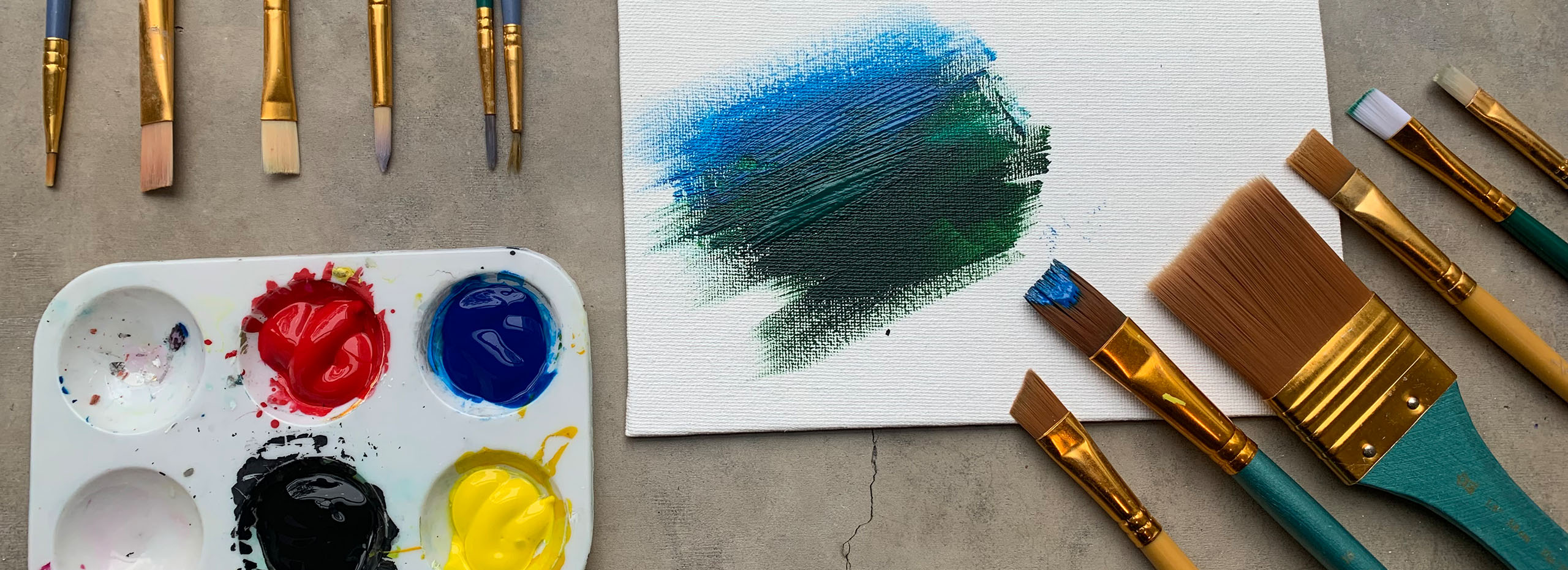 Paints and paintbrushes on a workshop table