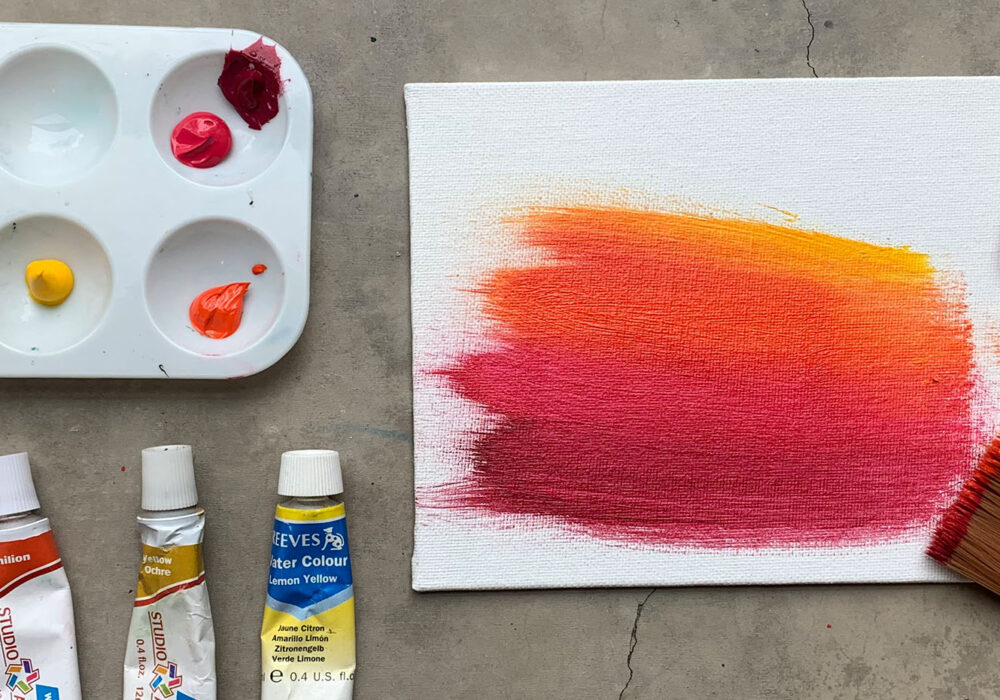 Paints and paintbrushes on a workshop table