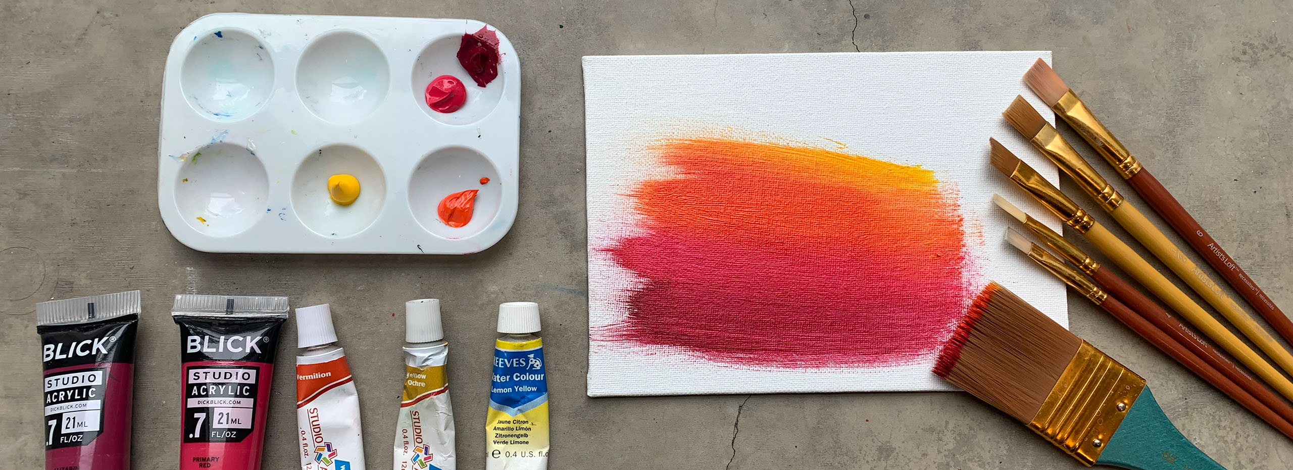 Paints and paintbrushes on a workshop table