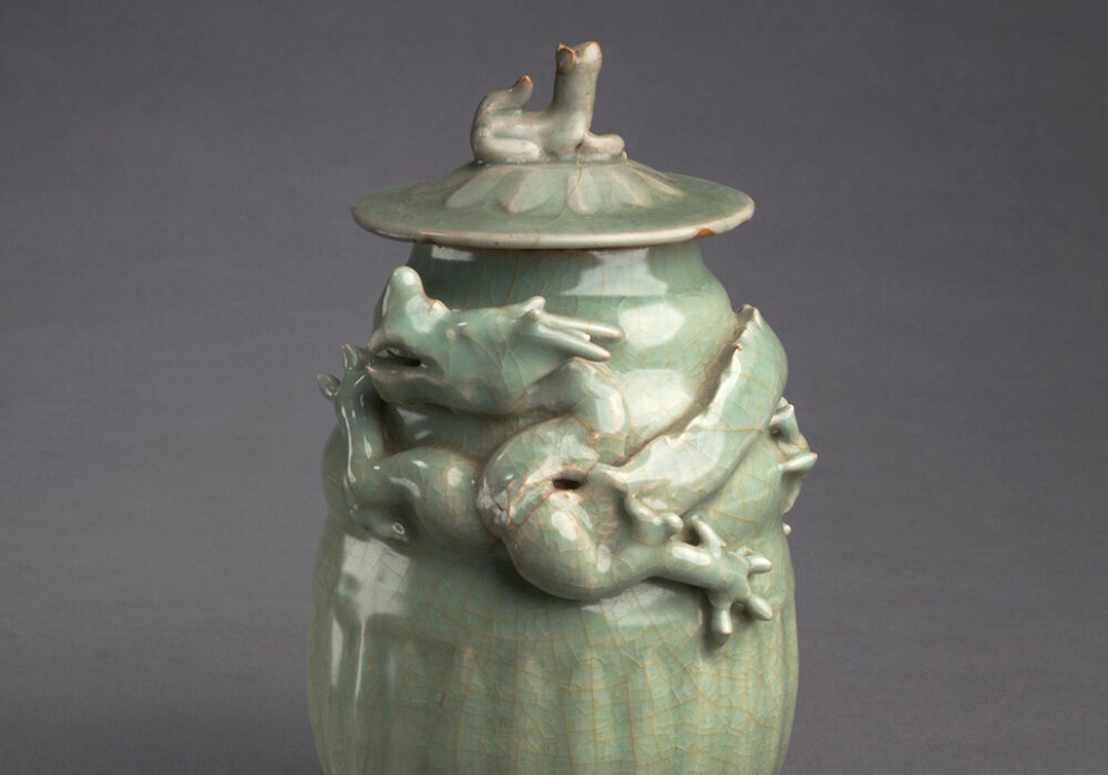 A small green Chinese jar with a dragon design