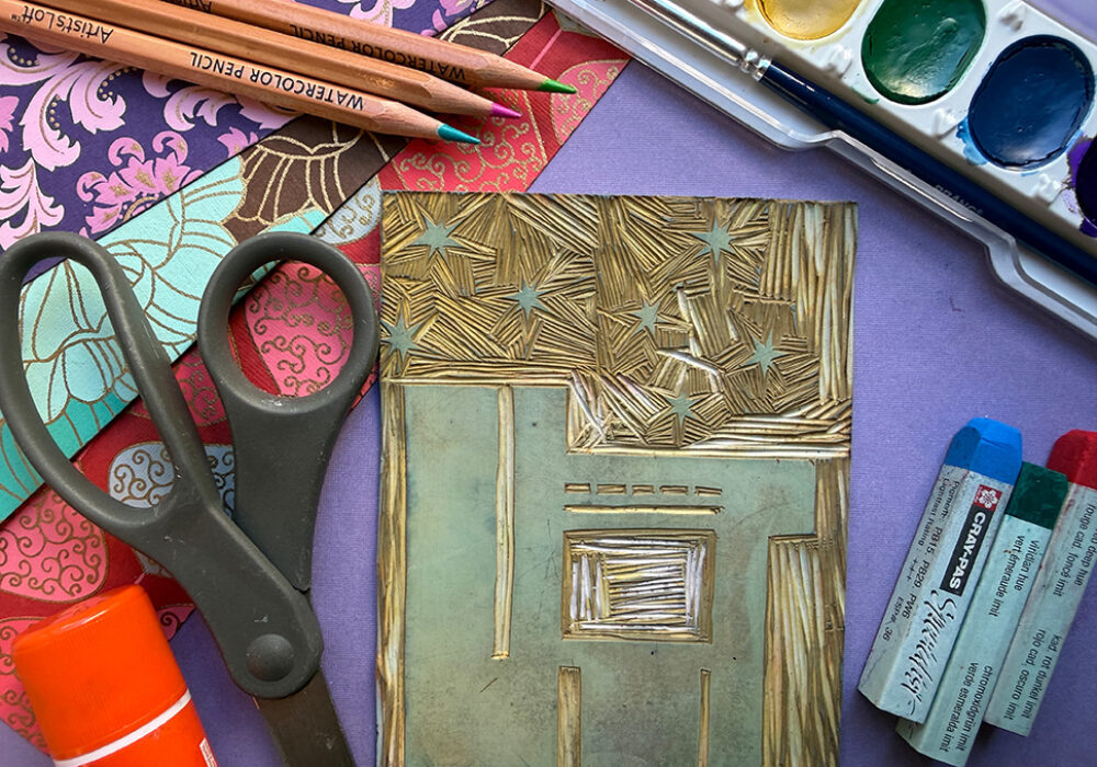 Colorful artmaking materials are displayed on a table